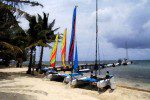 Catamarans at Caribbean Villas beach boat in belize